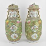 A pair of Chinese Canton Qing dynasty porcelain lidded vases, 19th century, of baluster form, each