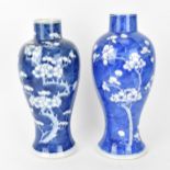 Two Chinese blue and white prunus vases, of baluster form with branches of blooming prunus on a blue