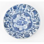 A small Chinese Kangxi period blue and white dish, of circular form with foliate motif, the