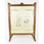 A Chinese embroidered silk picture, framed within a hardwood fire screen, the embroidered image