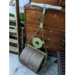 An early 20th century green painted cast iron Ransomes Sims and Jefferies garden roller with