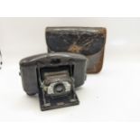 A Coronet Vogue Bakelite cased camera in a brown leather outer case Location:
