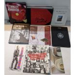 A collection of music anthology booklets including The Rolling Stones, King Crimson, Lou Reed,