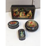 A group of four 20th century Russian boxes decorated with scenes to include two figures by a