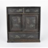 A Japanese Meiji period table top cabinet, late 19th century, in dark oak, with two short drawers