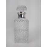 A Mills & Hersey glass spirits decanter with a silver collar, London 1973, with line cut