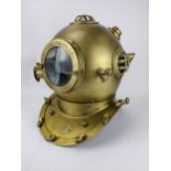 A reproduction brass diving helmet with a plaque inscribed 'Anchor Engineering Germany 1921' with