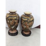 A pair of Meiji period Japanese Satsuma vases, decorated with painted portraits of gentleman, makers