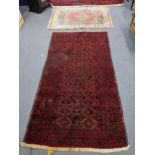 A hand woven Middle Eastern red ground rug having multi guard borders, together with a Turkish rug