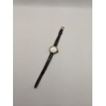 An early 20th Century 9ct gold cased ladies wrist watch on a leather strap. CAB2