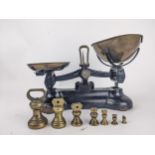 Libra Scale Co black painted cast iron scales with brass pans, and a graduated set of seven bell