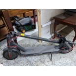 A black finished electric scooter Location: