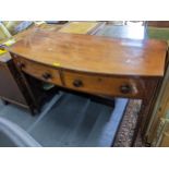A George III mahogany bow fronted side table having two drawers and on turned legs, ,86cm h x 119.