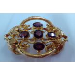 A late Victorian gold plated brooch having 5 purple cabochons. Location:Cab