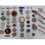A quantity of vintage jewellery, mainly brooches and bead necklaces, to include an oval Limoges
