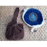 An early 20th Century smoking cap made of blue velvet with central embroidered and bejewelled emblem