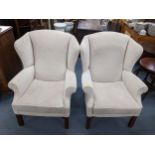 A pair of vintage cream upholstered wingback armchairs Location: