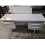 A white painted G-Plan teak dressing table with four drawers 70cm x 152cm x 45.5cm, and a matching