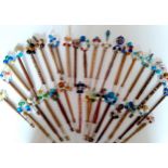 A collection of 19th and 20th Century ornate lace bobbins adorned with bead and coin spangles to