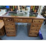 A Victorian mahogany twin pedestal writing desk having a green leather topped scriber and nine