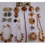 A collection of vintage amber coloured and citrine coloured costume jewellery to include a 9ct