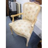 A pair of vintage French style beech bedroom chair having floral upholstery and on front cabriole