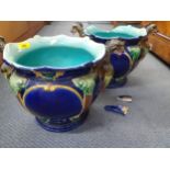 A pair of Majolica planters having a blue ground with green, yellow and brown acanthus and serpent