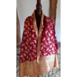 An Indian red and gold silk wrap with gold coloured metallic thread knotted tassel fringe 176cm Long