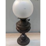 A Victorian embossed decorated brass oil lamp, with frosted shade Location: A3M