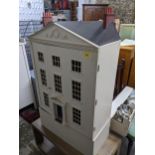 A modern dolls house in sections with opening front and a large collection of furniture and