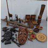 Mixed treen items to include carved wooden masks, carved wooden fish, together with carved animals