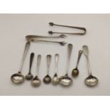 A selection of Georgian and later silver condiment spoons together with two solver sugar nips, 80.7g