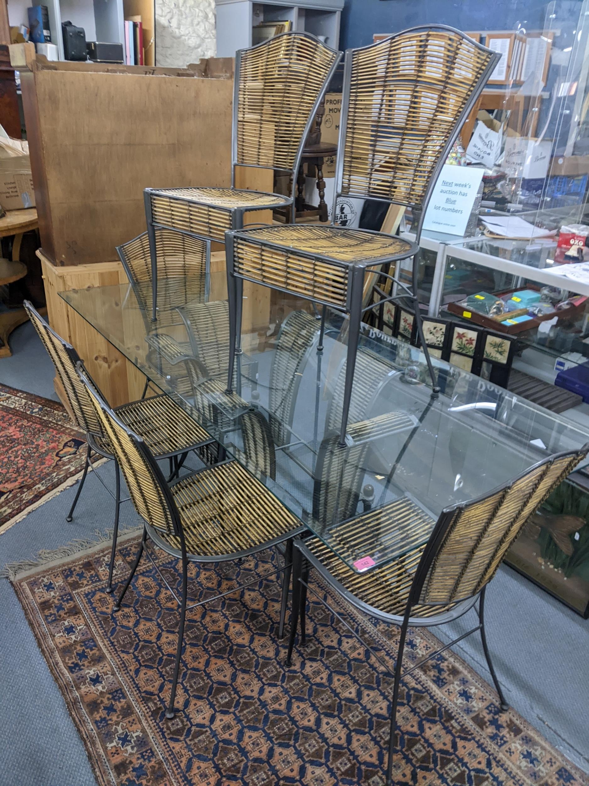 A wrought metal and bamboo framed dining table having a glass top, 76h x 190w, together with six