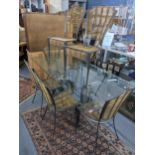 A wrought metal and bamboo framed dining table having a glass top, 76h x 190w, together with six