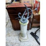 A brass sundial on a weathered concrete fluted column pedestal and stepped base, A/F, Location: