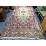 A hand woven Turkish red ground rug having a central motif and a beige centre, 276 x 180w, Location: