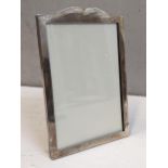 A silver photograph frame on an easel back Location: