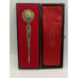 A silver letter opener having a 1952-1927 Silver Jubilee commemorative crown, total weight 66.9g,