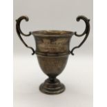 An early 20th century silver twin handled small trophy with engraving, 72.8g, Location: