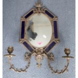 A 1930's French brass and blue glazed pottery wall mirror with two incorporated candle holders