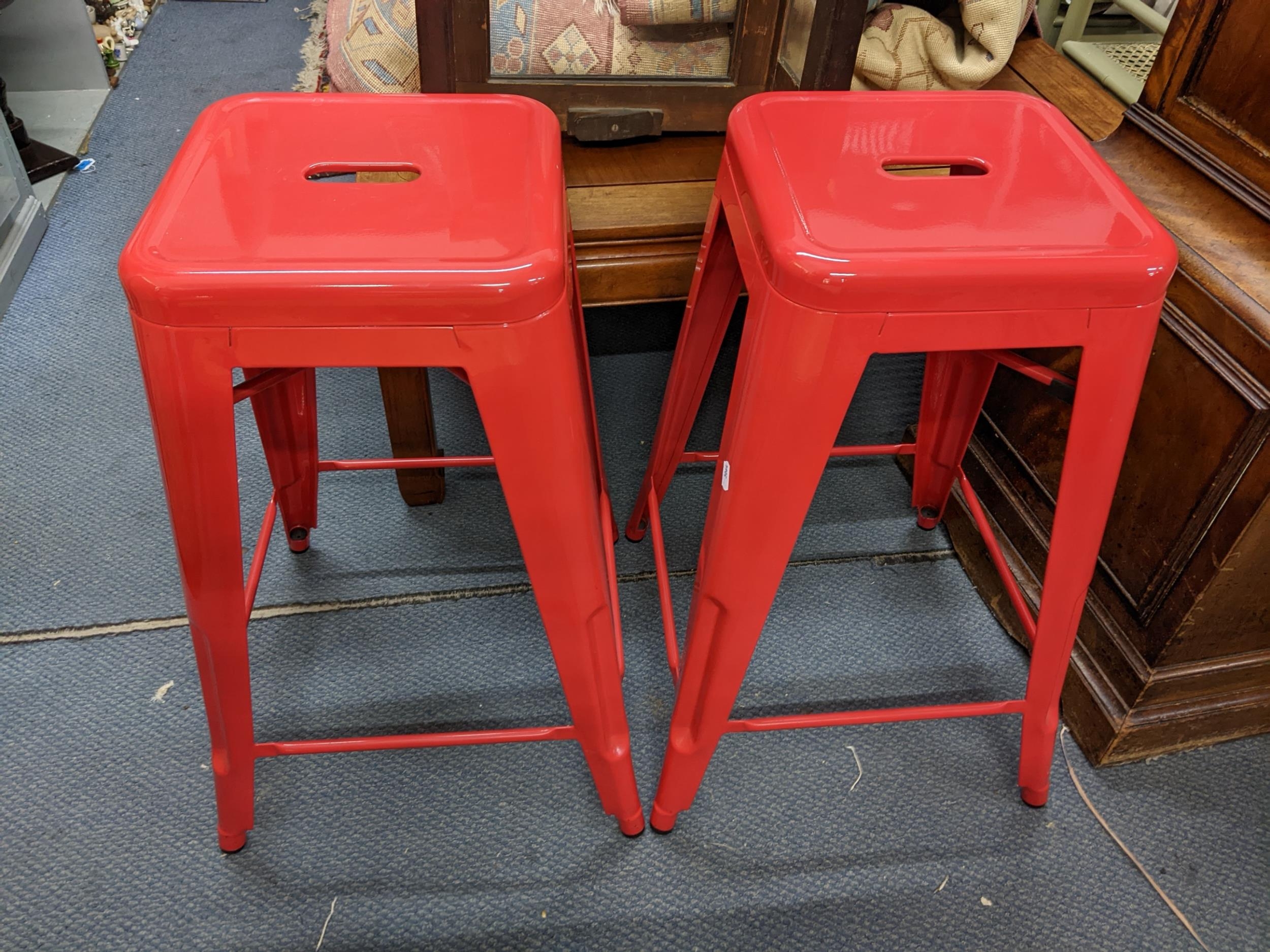 A pair of red painted metal bar stools, Location: