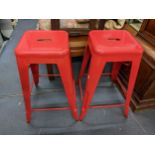 A pair of red painted metal bar stools, Location: