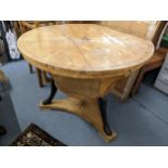 A 19th century Scandinavian satinwood circular topped, two tier table having marquetry inlay and