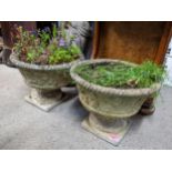 A pair of garden stoneware planters of floral design and raised on square bases, 32H x 40.5w,