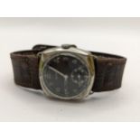 A Helma German military wristwatch in a cushion moulded case and on a leather strap, Location: