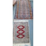 A 20th century blue and brown ground rug together with a small cream scatter/pray Location: