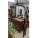 A large cast iron garden arch having scroll work design, with grapes and vines, 253h x 164.5w,