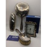 A boxed silver fronted R Carr clock with paperwork, hallmarked Sheffield 1997, together with a three