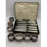 Six late 19th/early 20th century silver napkin rings and a silver bangle 150.7g, together with a