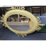 A white painted metal framed oval mirror having applied floral decoration, A/F, Location: